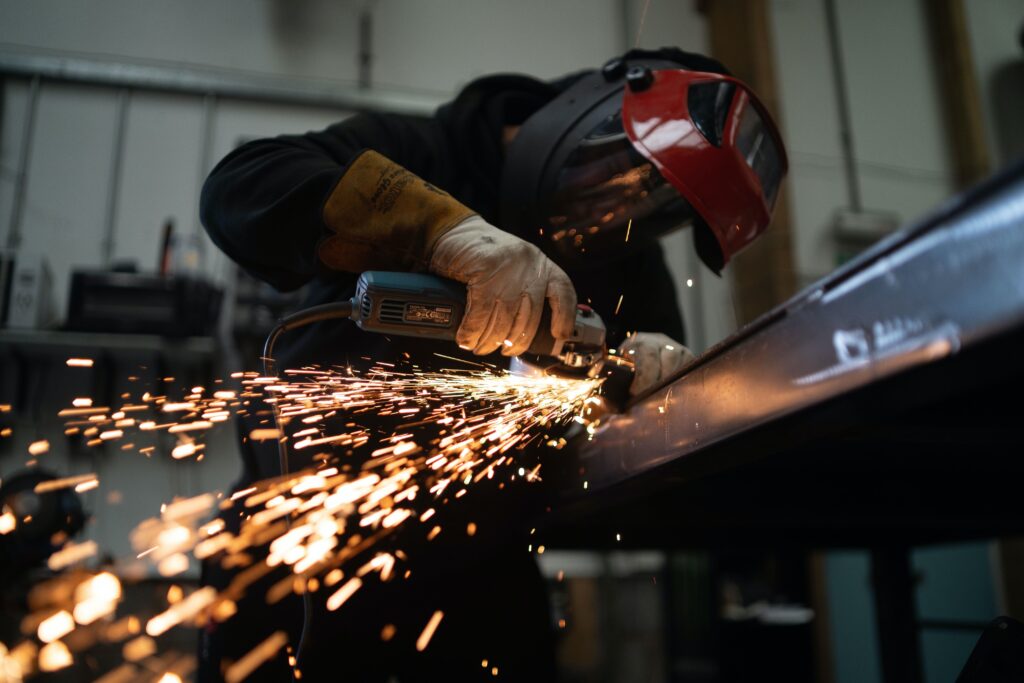 Worker grinding a piece of metal