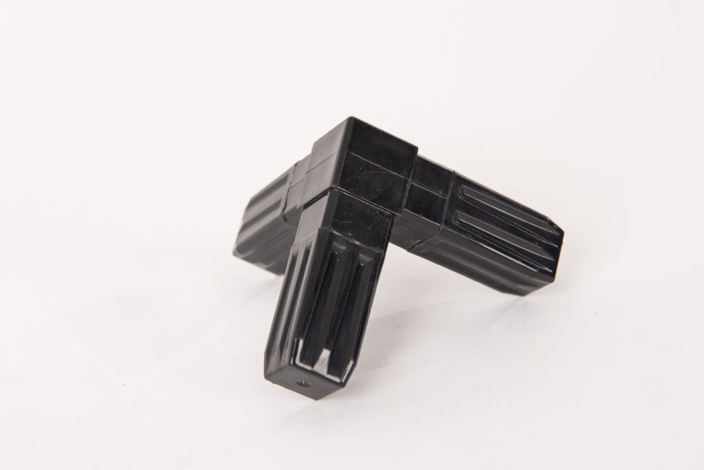 Black molded plastic corner connector piece.